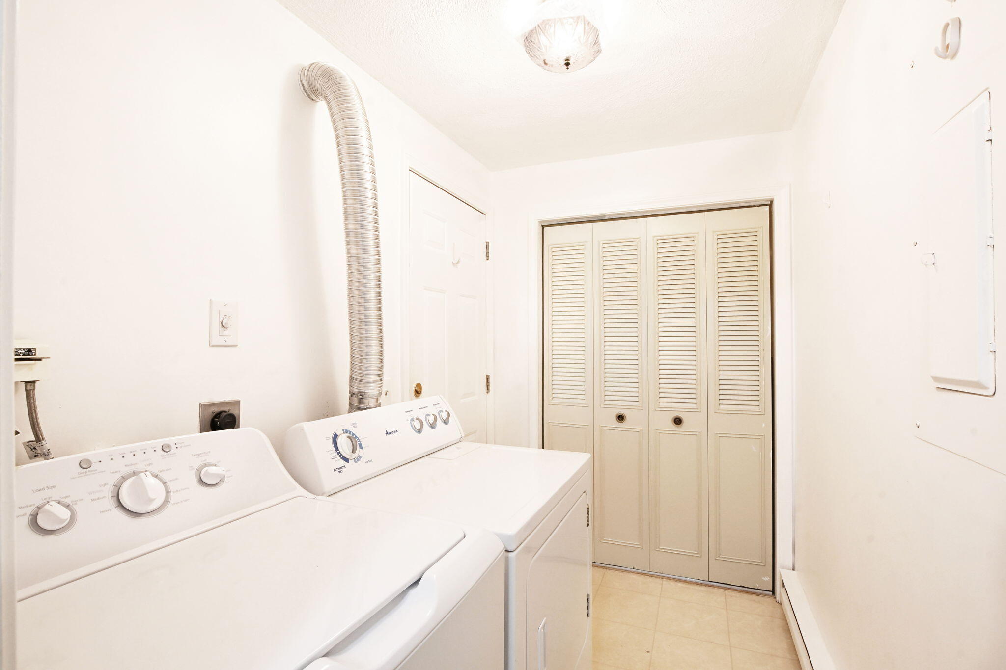 48 Highview Drive, Unit 48 Sandwich, MA 02563 - Photo 12 of 33 a room with a bed and a washer