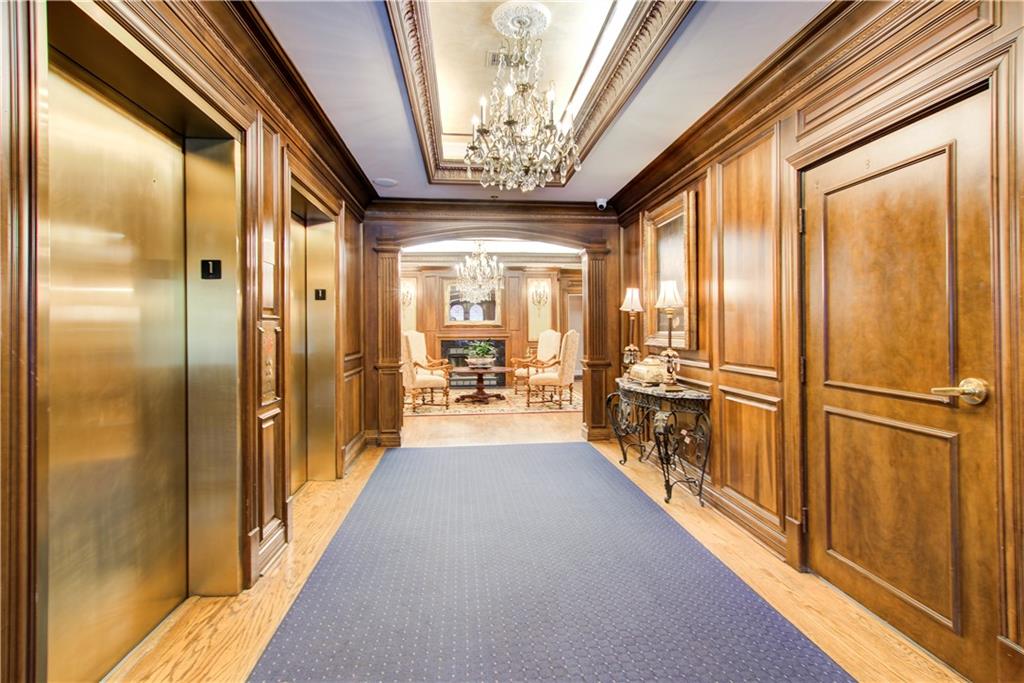 2865 Lenox Road Northeast, Unit 102 Atlanta, GA 30324 - Photo 35 of 35 a view of a hallway with the couches and chandelier