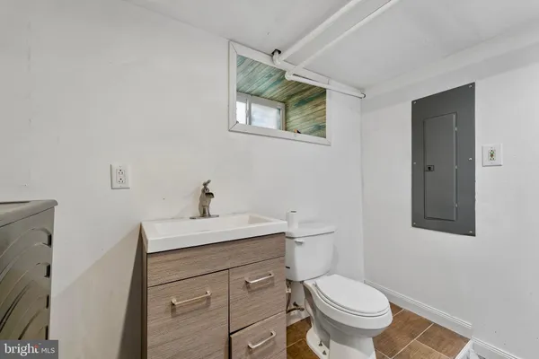 a bathroom with a toilet a sink and mirror