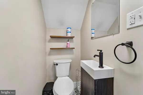 a bathroom with a toilet sink and mirror