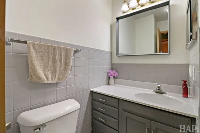 a bathroom with a sink a toilet and mirror