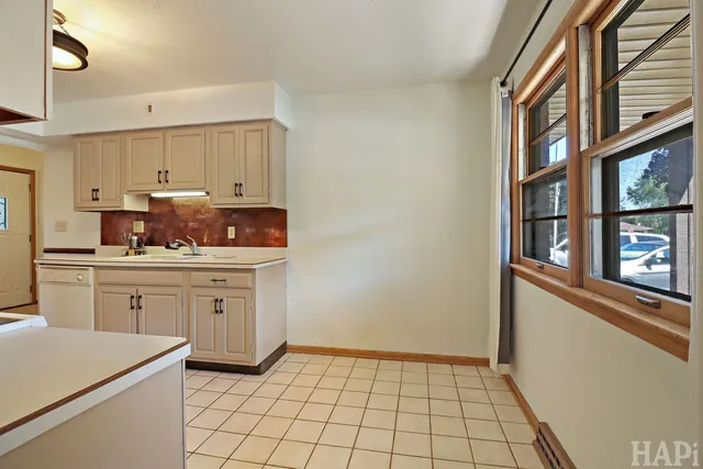 a kitchen with a sink cabinets and window