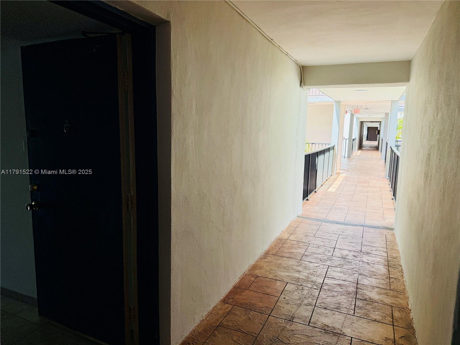 30 East 39th Street, Unit 217 Hialeah, FL 33013 - Photo 11 of 50 a hallway with a view of bedroom