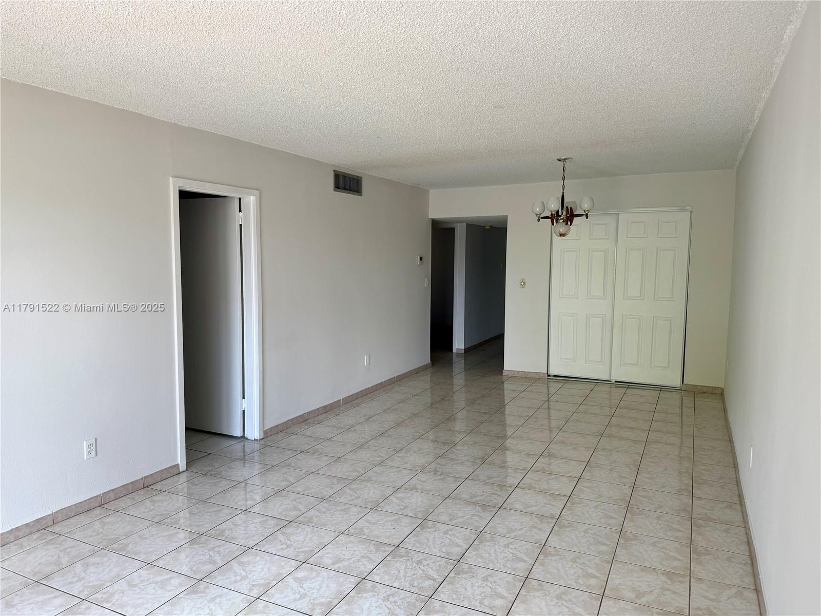 30 East 39th Street, Unit 217 Hialeah, FL 33013 - Photo 15 of 50 an empty room with kitchen view and natural light