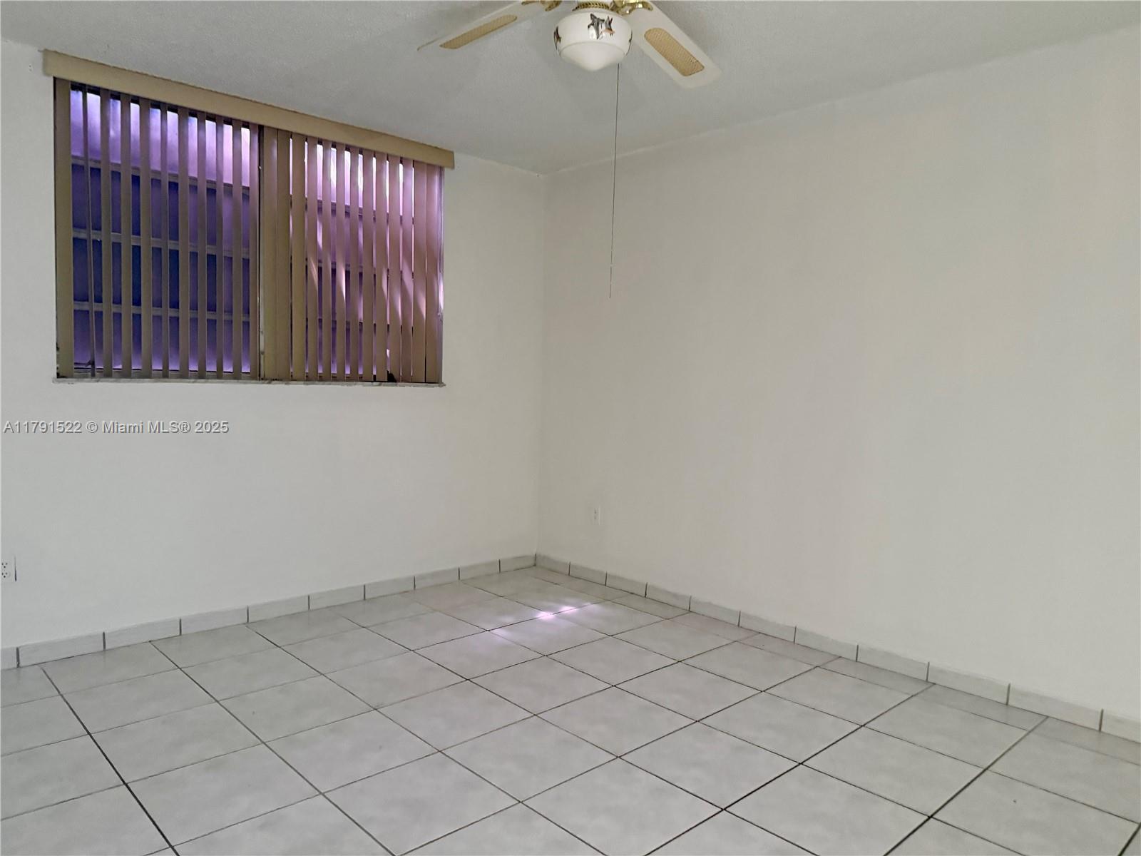 30 East 39th Street, Unit 217 Hialeah, FL 33013 - Photo 20 of 50 an empty room with wooden floor and windows