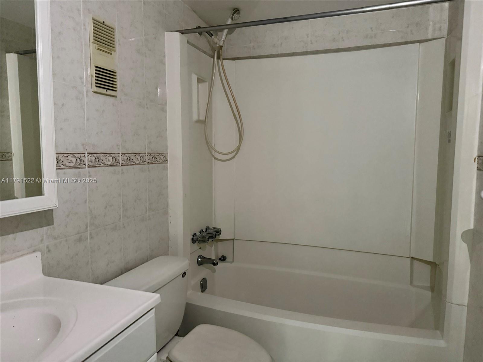 30 East 39th Street, Unit 217 Hialeah, FL 33013 - Photo 23 of 50 a bathroom with a shower curtain and a bath tub