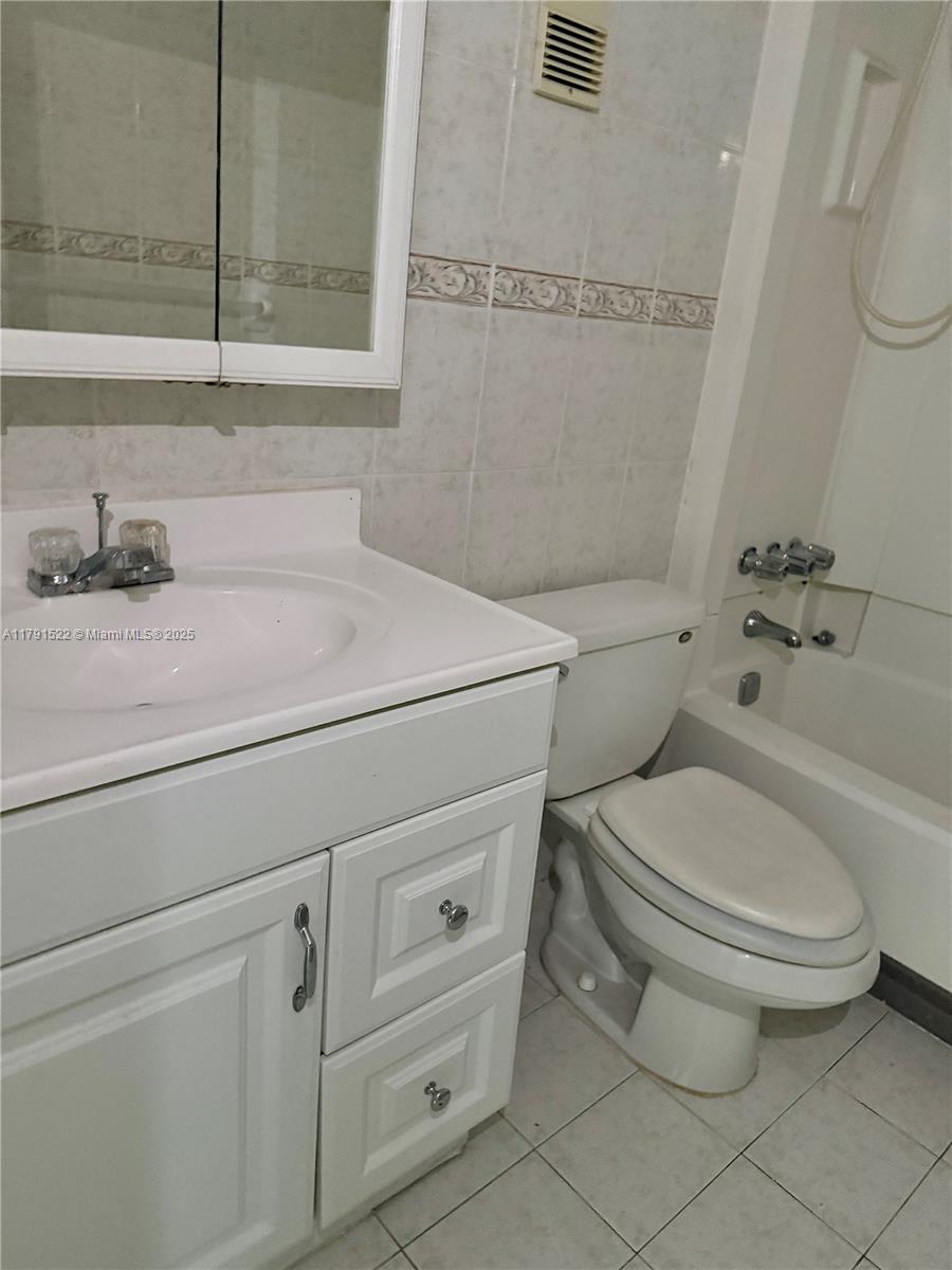 30 East 39th Street, Unit 217 Hialeah, FL 33013 - Photo 26 of 50 a bathroom with a toilet sink and mirror