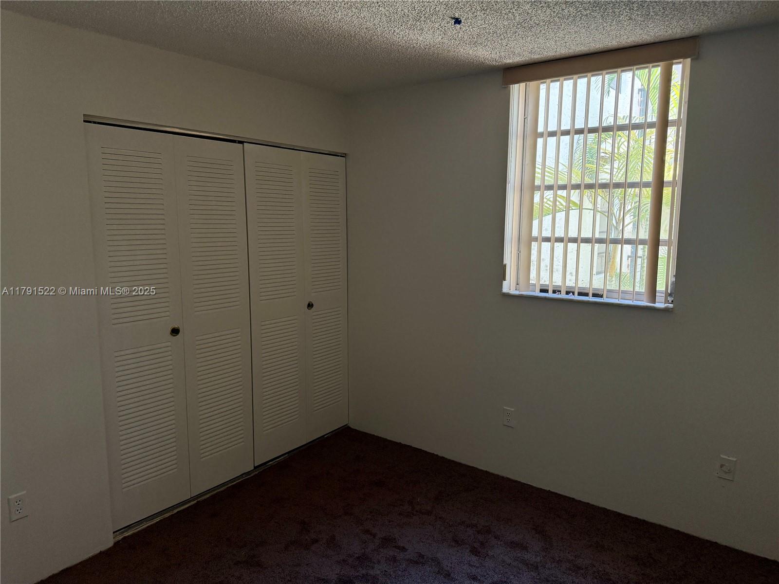 30 East 39th Street, Unit 217 Hialeah, FL 33013 - Photo 27 of 50 an empty room with a window
