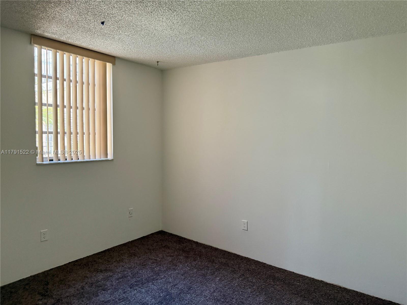 30 East 39th Street, Unit 217 Hialeah, FL 33013 - Photo 29 of 50 an empty room with a window