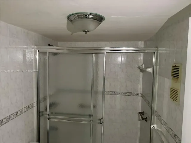 a bathroom with a shower and toilet