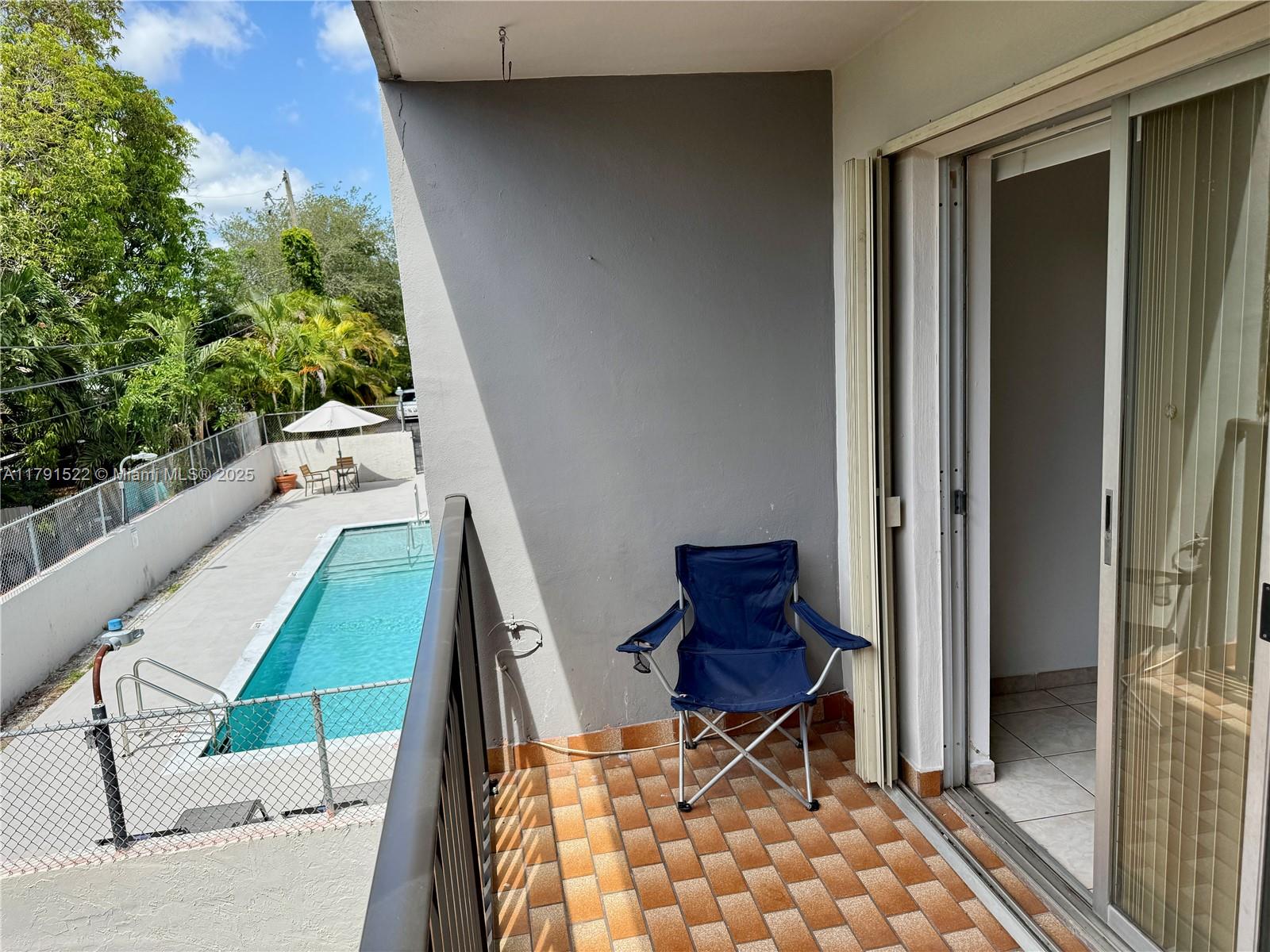 30 East 39th Street, Unit 217 Hialeah, FL 33013 - Photo 3 of 50 a balcony with table and chairs