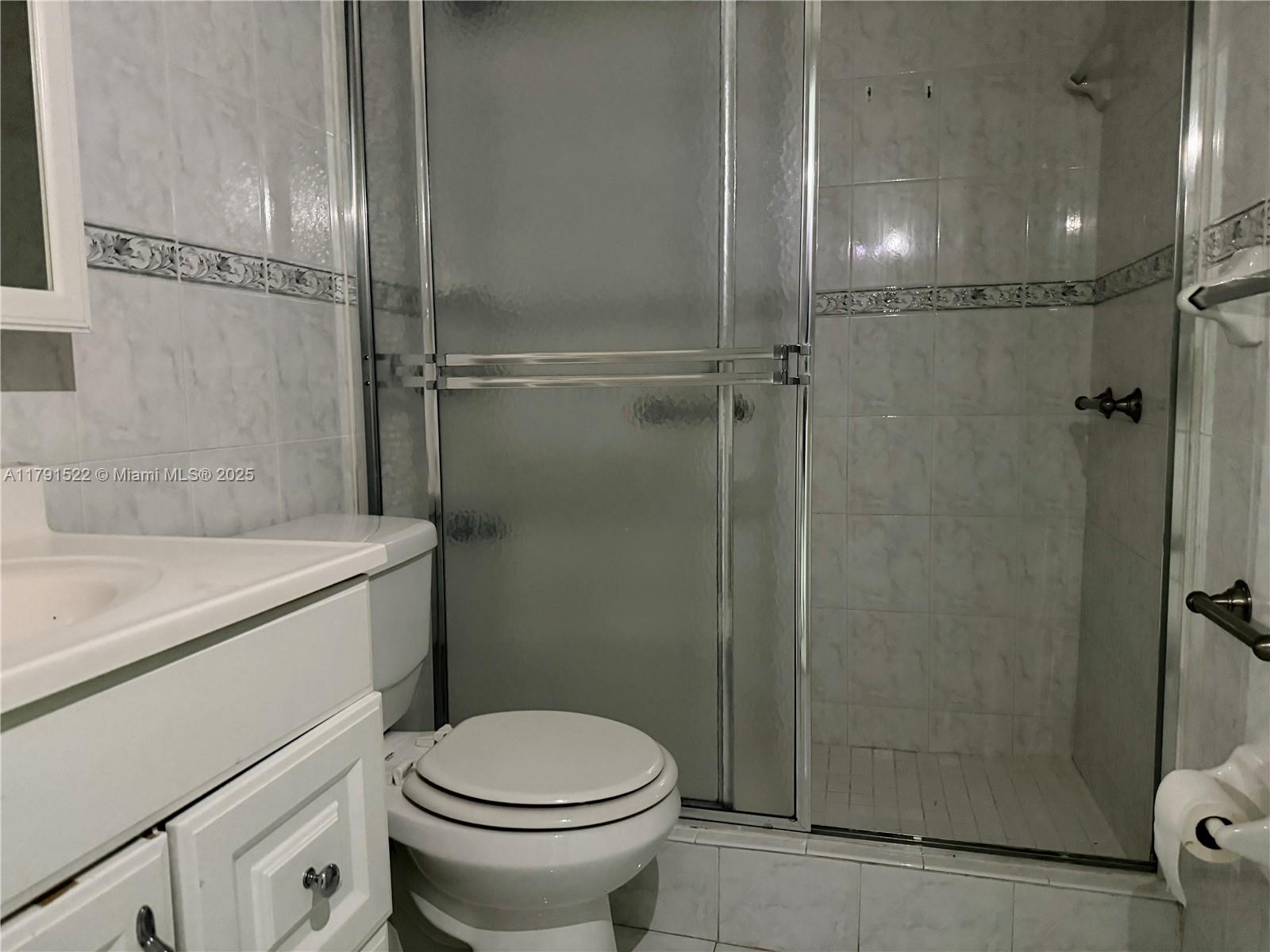 30 East 39th Street, Unit 217 Hialeah, FL 33013 - Photo 31 of 50 a bathroom with a granite countertop sink toilet and shower