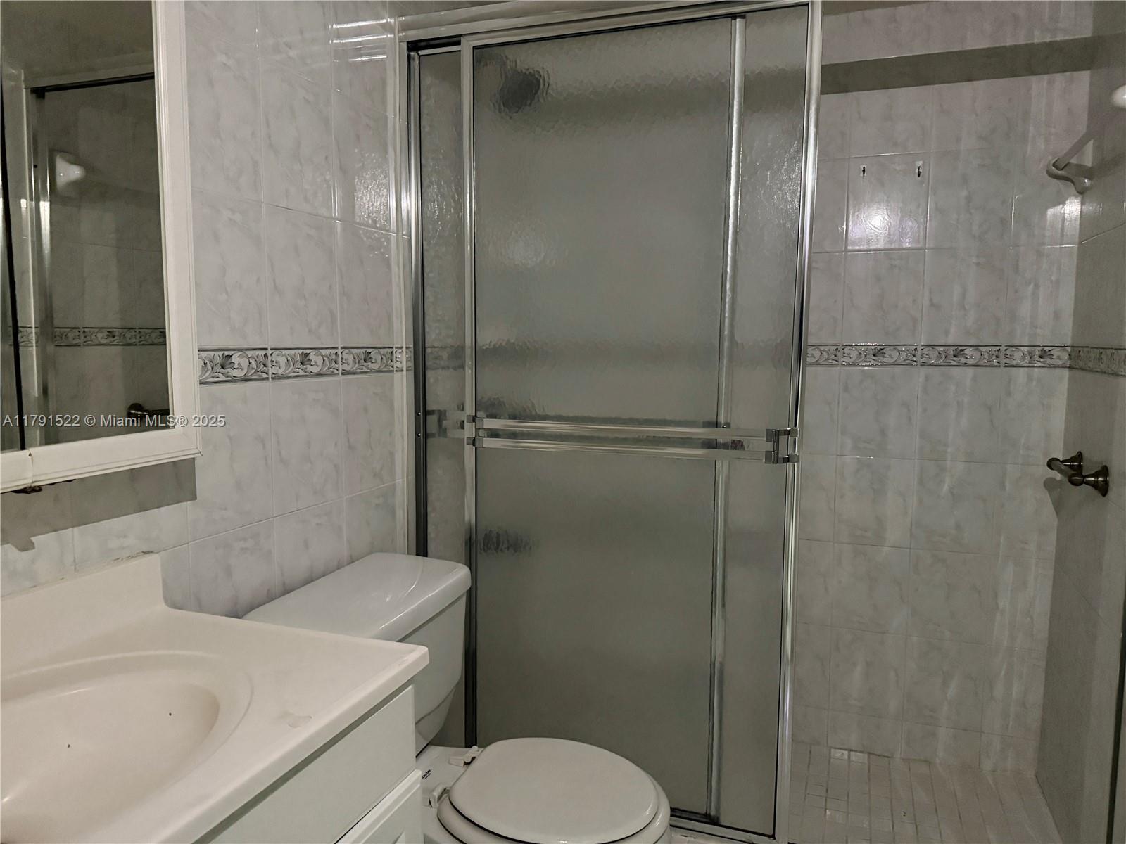 30 East 39th Street, Unit 217 Hialeah, FL 33013 - Photo 32 of 50 a bathroom with a shower and toilet