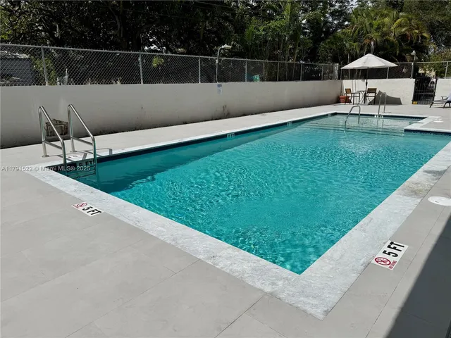 a view of a backyard with sitting area