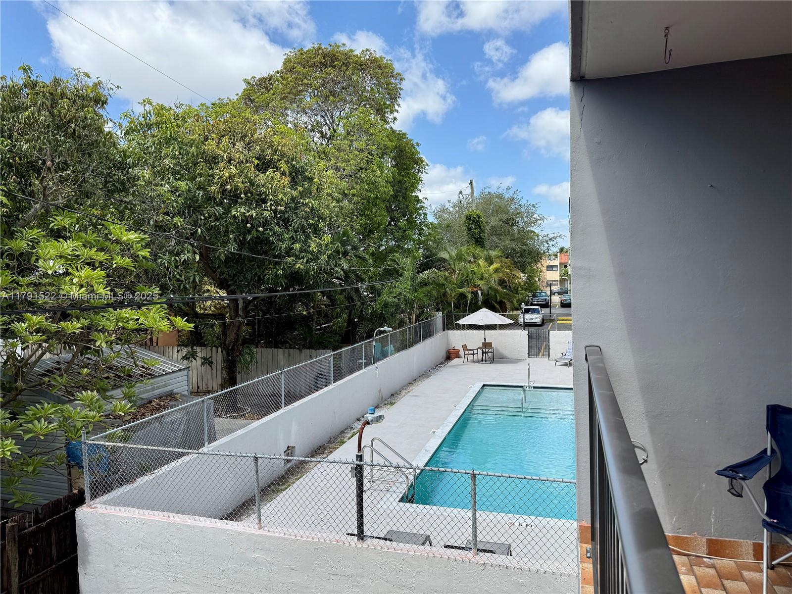 30 East 39th Street, Unit 217 Hialeah, FL 33013 - Photo 4 of 50 a view of a swimming pool with a patio