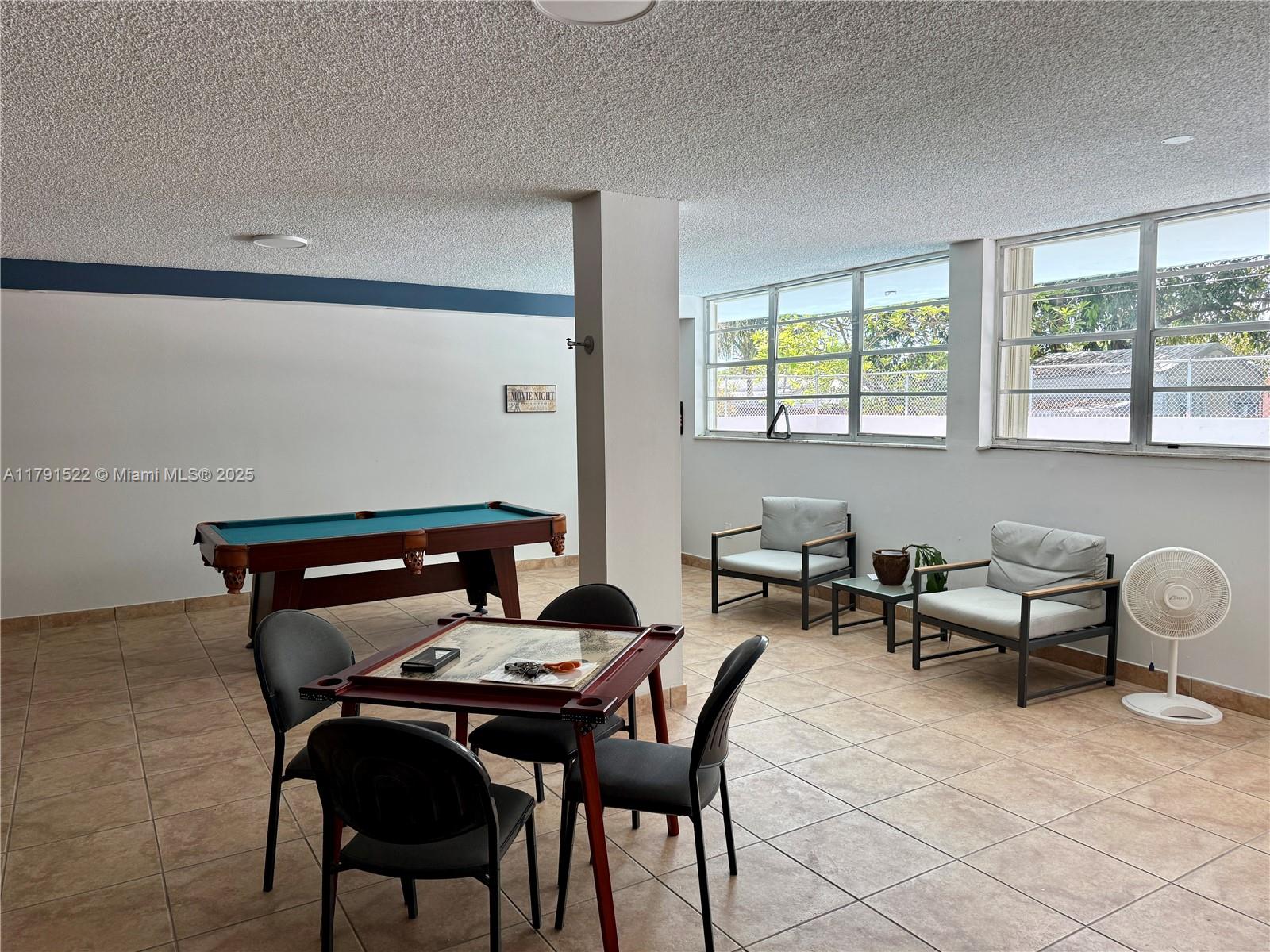 30 East 39th Street, Unit 217 Hialeah, FL 33013 - Photo 41 of 50 a patio with a table and chairs