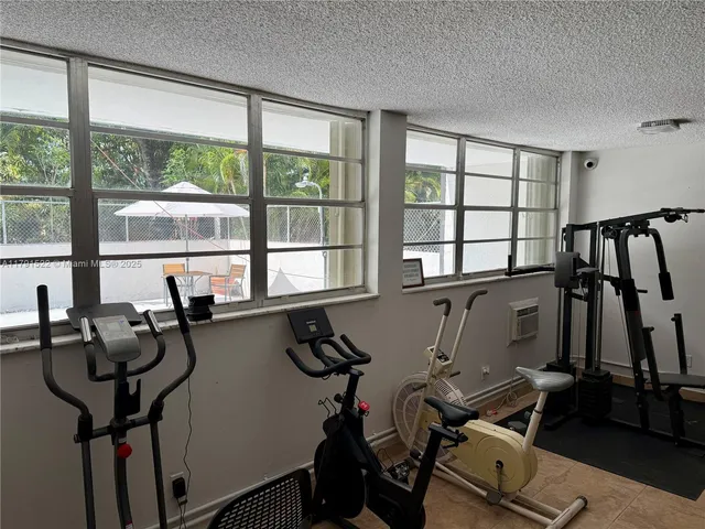 a room with gym equipment and a large window