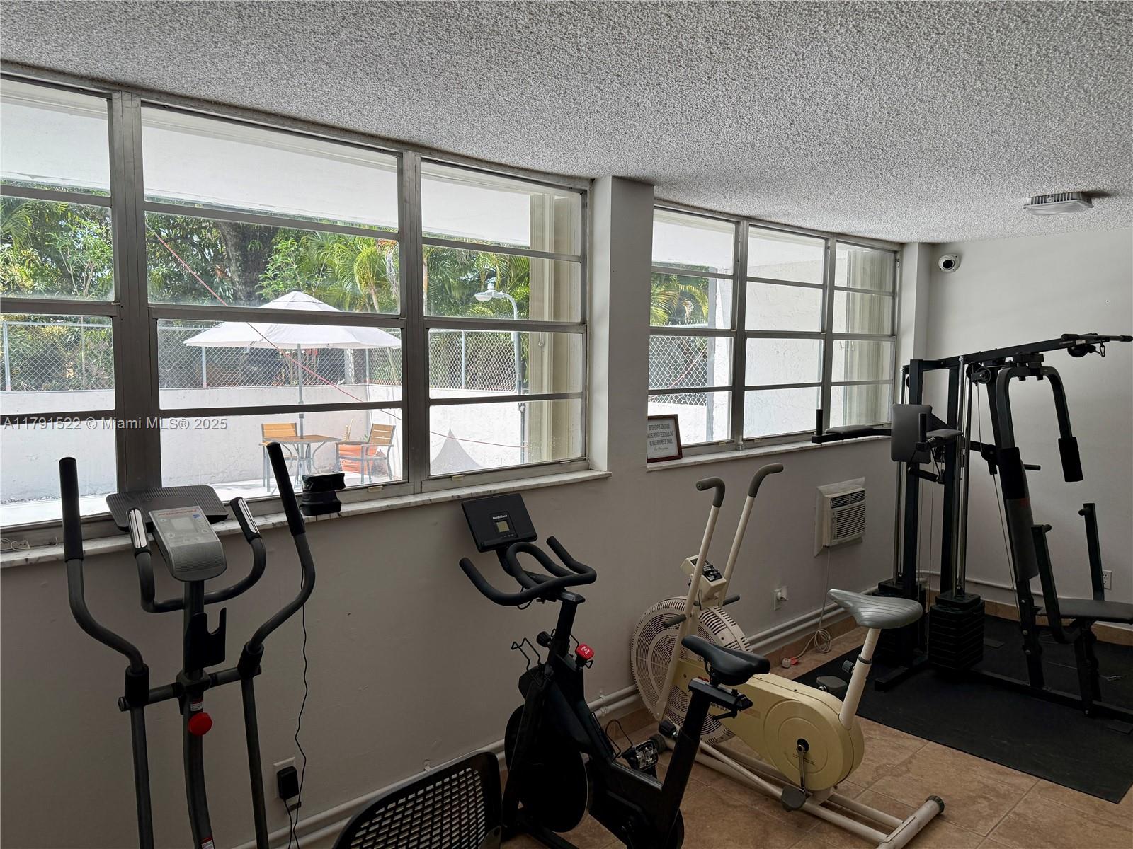 30 East 39th Street, Unit 217 Hialeah, FL 33013 - Photo 43 of 50 a room with gym equipment and windows