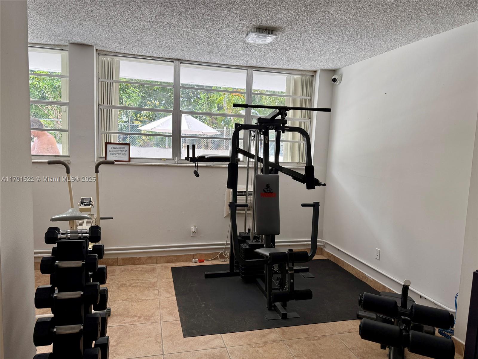 30 East 39th Street, Unit 217 Hialeah, FL 33013 - Photo 44 of 50 a room with gym equipment and a window