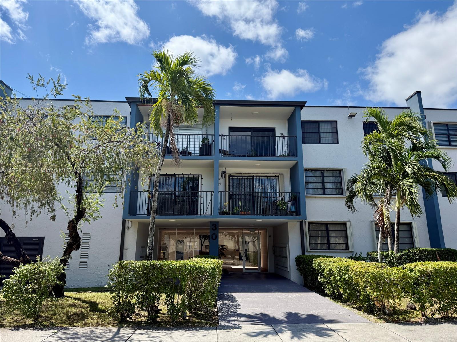 30 East 39th Street, Unit 217 Hialeah, FL 33013 - Photo 48 of 50 a front view of a house with a garden
