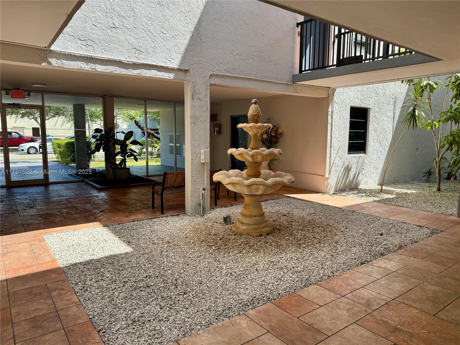 30 East 39th Street, Unit 217 Hialeah, FL 33013 - Photo 8 of 50 a view of a livingroom with wooden floor and a chandelier