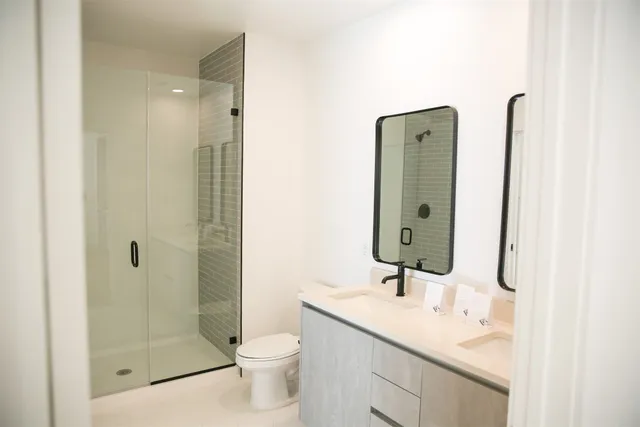 a bathroom with a toilet and a shower