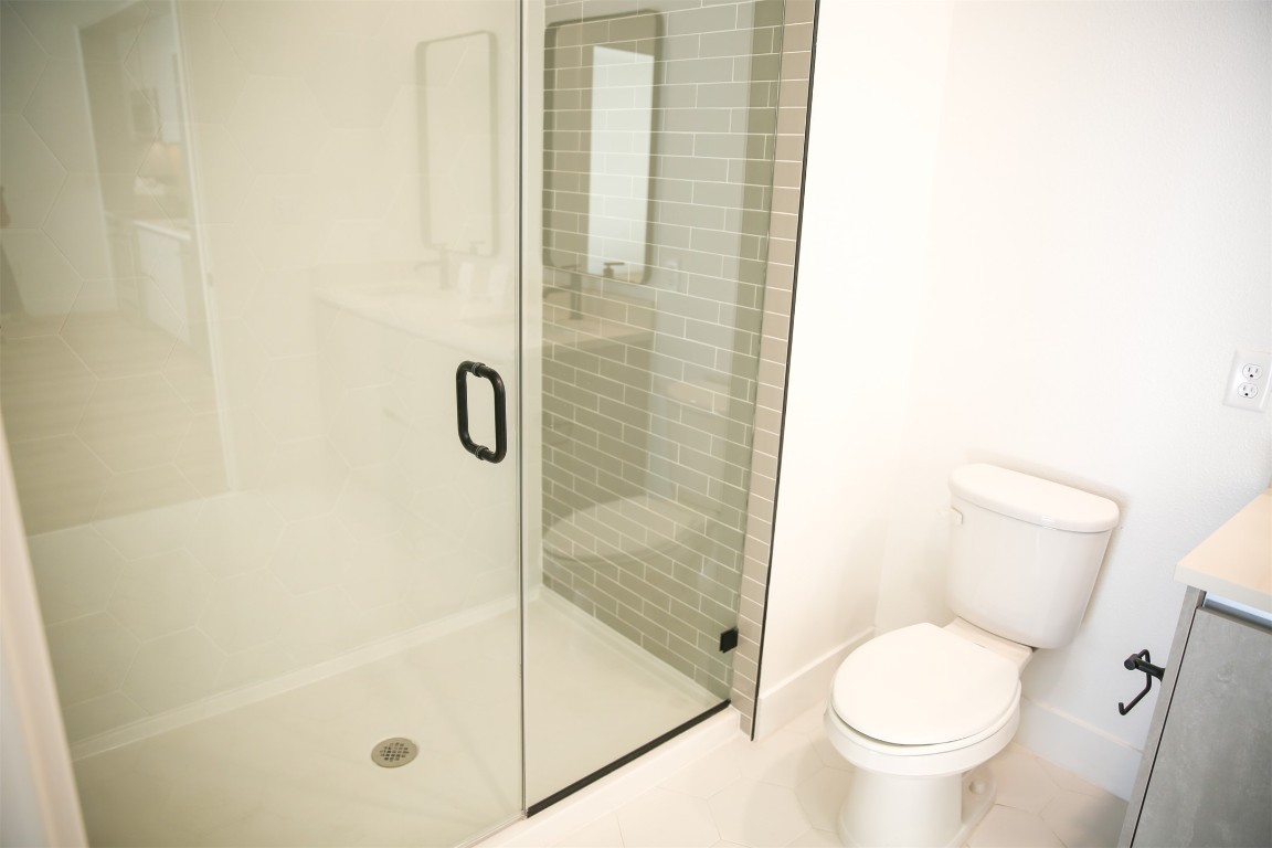 4315 South Congress Avenue, Unit 207 Austin, TX 78745 - Photo 10 of 12 a bathroom with a toilet and a shower