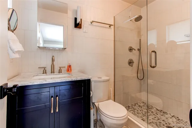 a bathroom with a sink toilet and shower