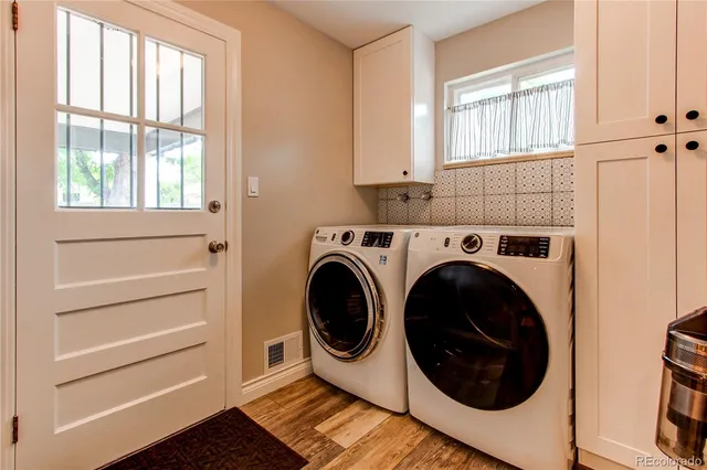 a utility room with sink dryer and washer