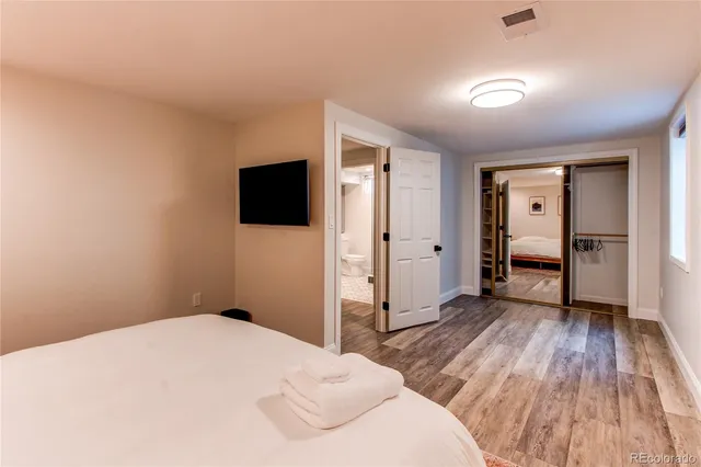 a bedroom with a bed and a flat screen tv