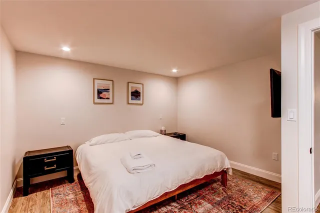 a bedroom with a bed and a night stand