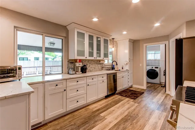 a open kitchen with stainless steel appliances granite countertop a stove a sink and a refrigerator