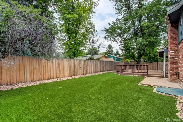 a view of a backyard with wooden fence