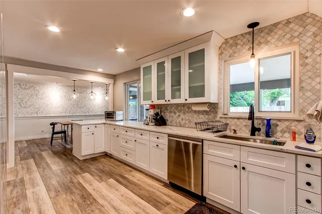 a kitchen with a sink stove and cabinets