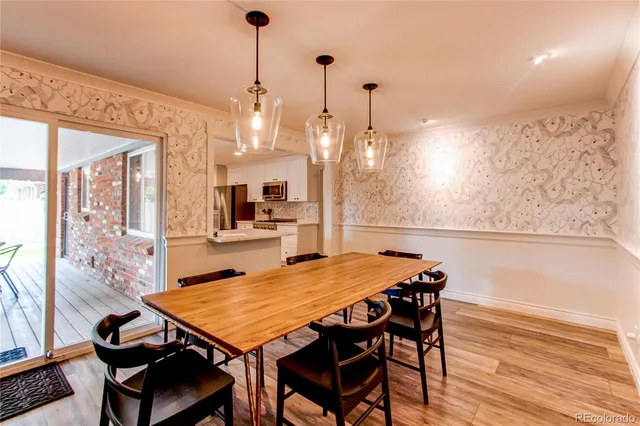a dining room with furniture and wooden floor