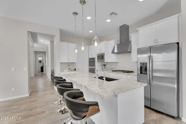 a kitchen with a sink stainless steel appliances and cabinets