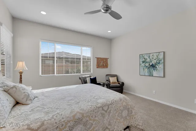 a bedroom with a large bed and a window