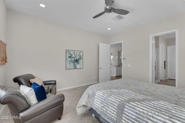 a bedroom with bed furniture and a ceiling fan