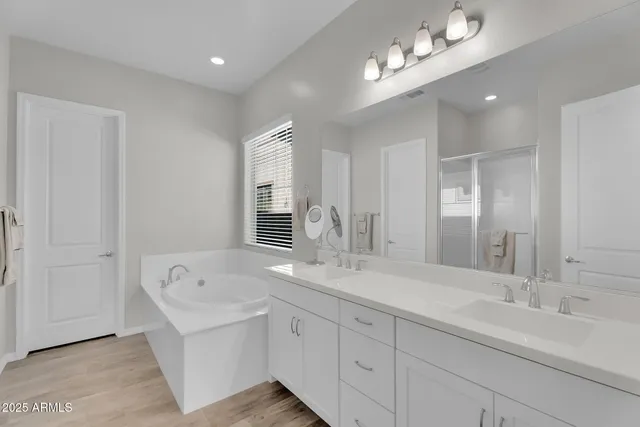 a spacious bathroom with a double vanity sink and a mirror