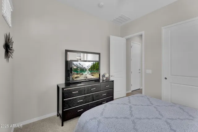 a room with a bed and a television