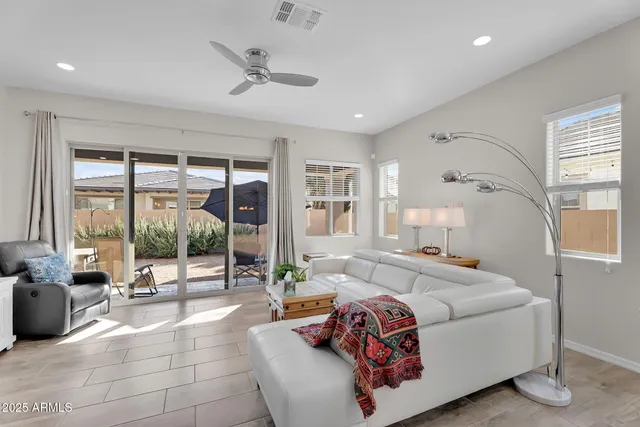 a living room with furniture and large windows
