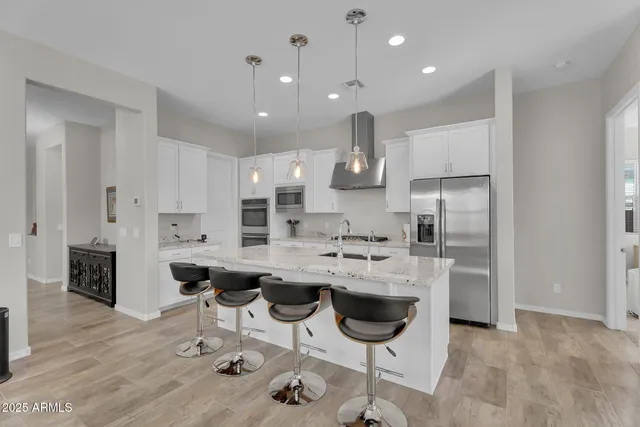 a kitchen with stainless steel appliances kitchen island granite countertop a sink and cabinets