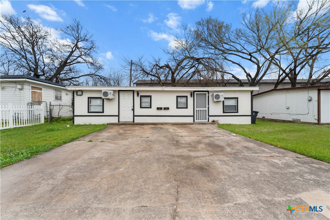 508 Rhode Island Street Killeen, TX 76541 - Photo 1 of 8 a view of a white house with a big yard and large trees
