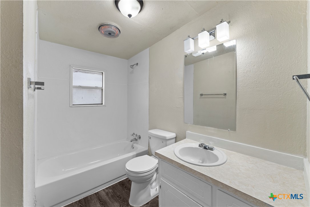 508 Rhode Island Street Killeen, TX 76541 - Photo 4 of 8 a bathroom with a toilet a sink a tub and a mirror