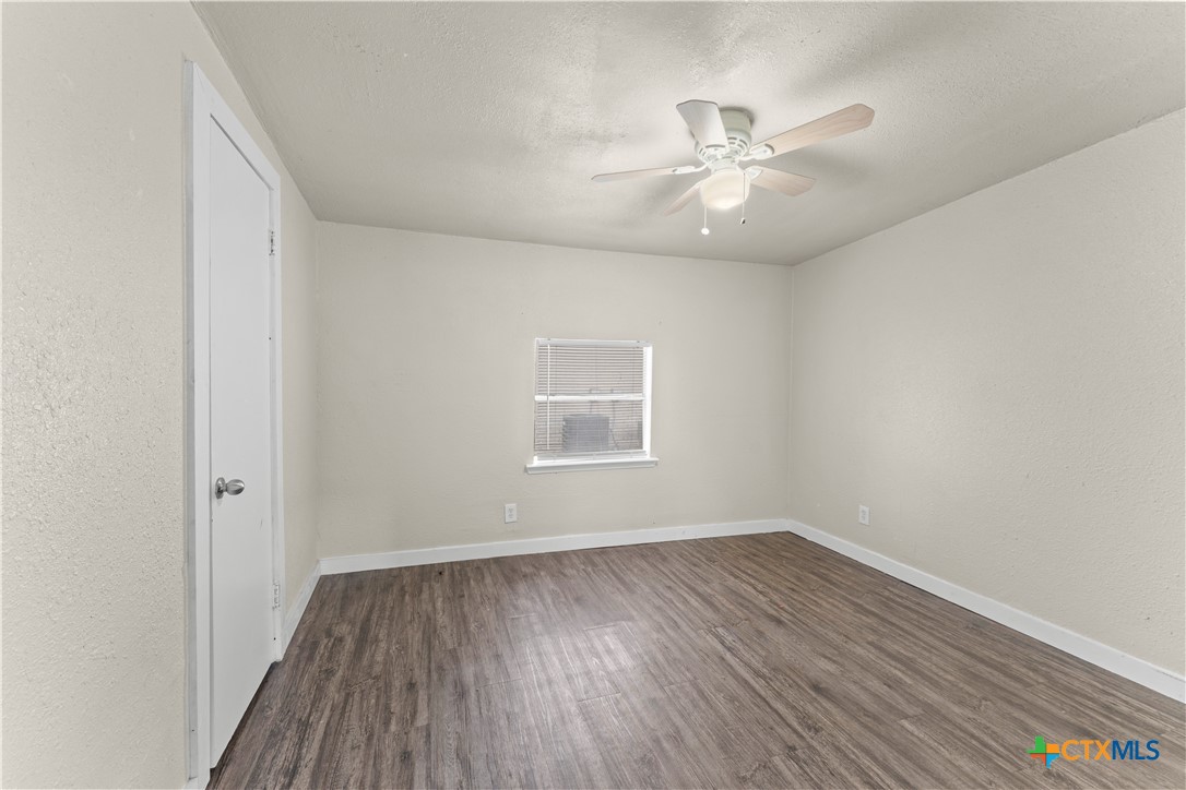 508 Rhode Island Street Killeen, TX 76541 - Photo 6 of 8 wooden floor in an empty room with a window
