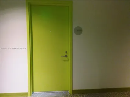 a bedroom with a bed and painting on the wall