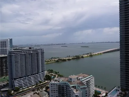 a view of a lake with a city skyline in the background