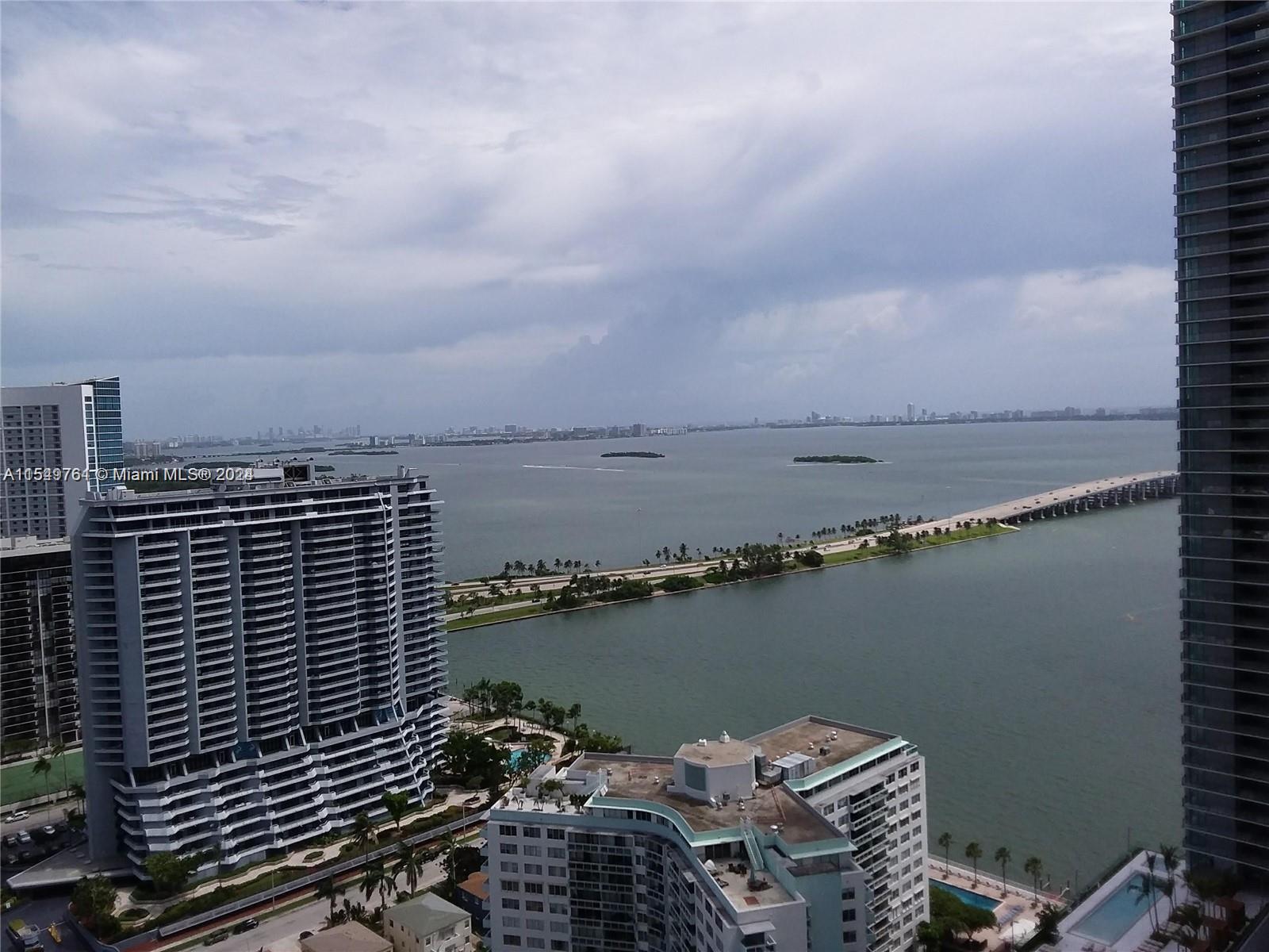501 Northeast 31st Street, Unit 3003 Miami, FL 33137 - Photo 2 of 28 a view of a lake with a city skyline in the background