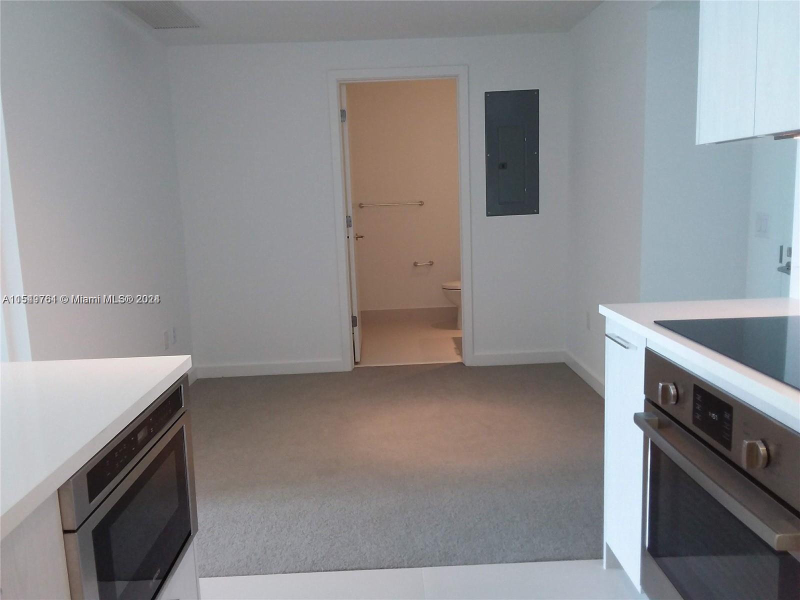 501 Northeast 31st Street, Unit 3003 Miami, FL 33137 - Photo 10 of 28 a kitchen with a sink and a stove top oven
