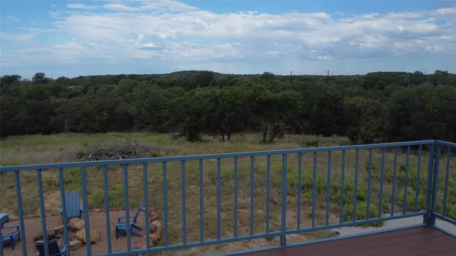 a view of a lush green forest with a lake